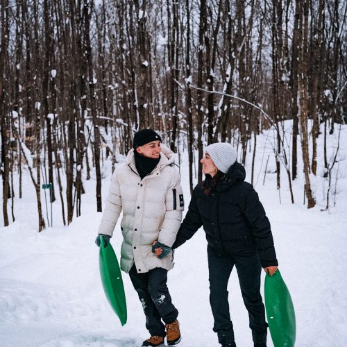 couple marchant dans la neige avec luges au domaine Le Vertendre au Québec
